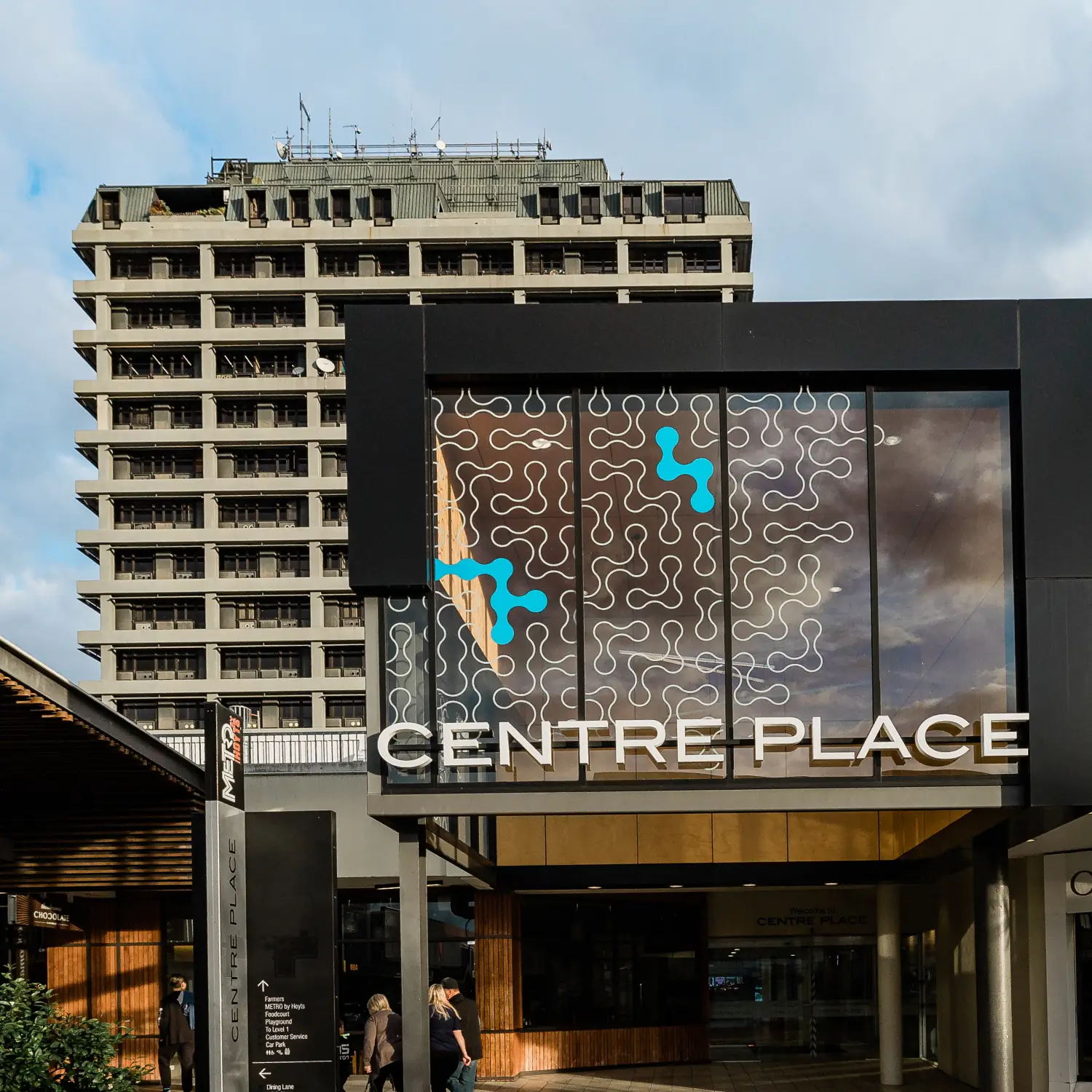Centre Place shopping center entrance with decorative glass panels and the building behind it; the sign CENTRE PLACE visible above the entrance.